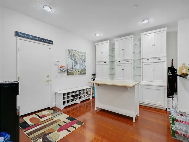 a living room with hard wood flooring and furniture