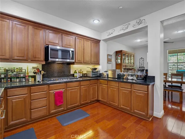 a kitchen with stainless steel appliances granite countertop wooden cabinets a sink and dishwasher