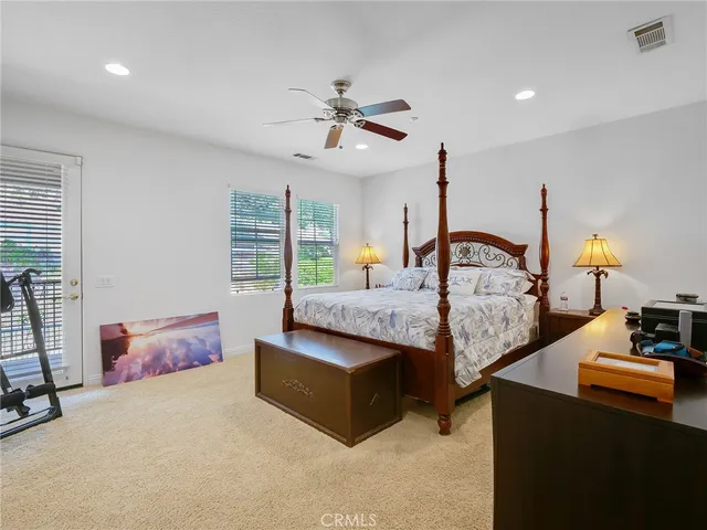a bedroom with bed and a chandelier