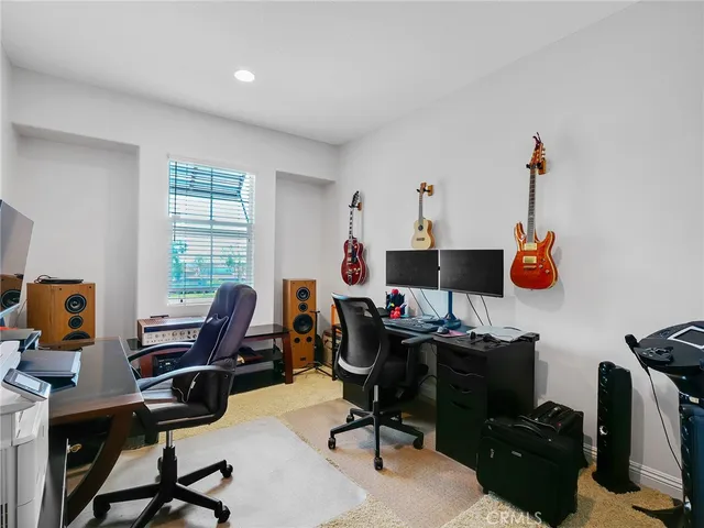 a view of a workspace with furniture and a window