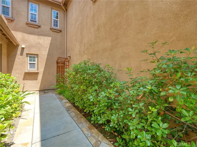 a view of a pathway both side of house