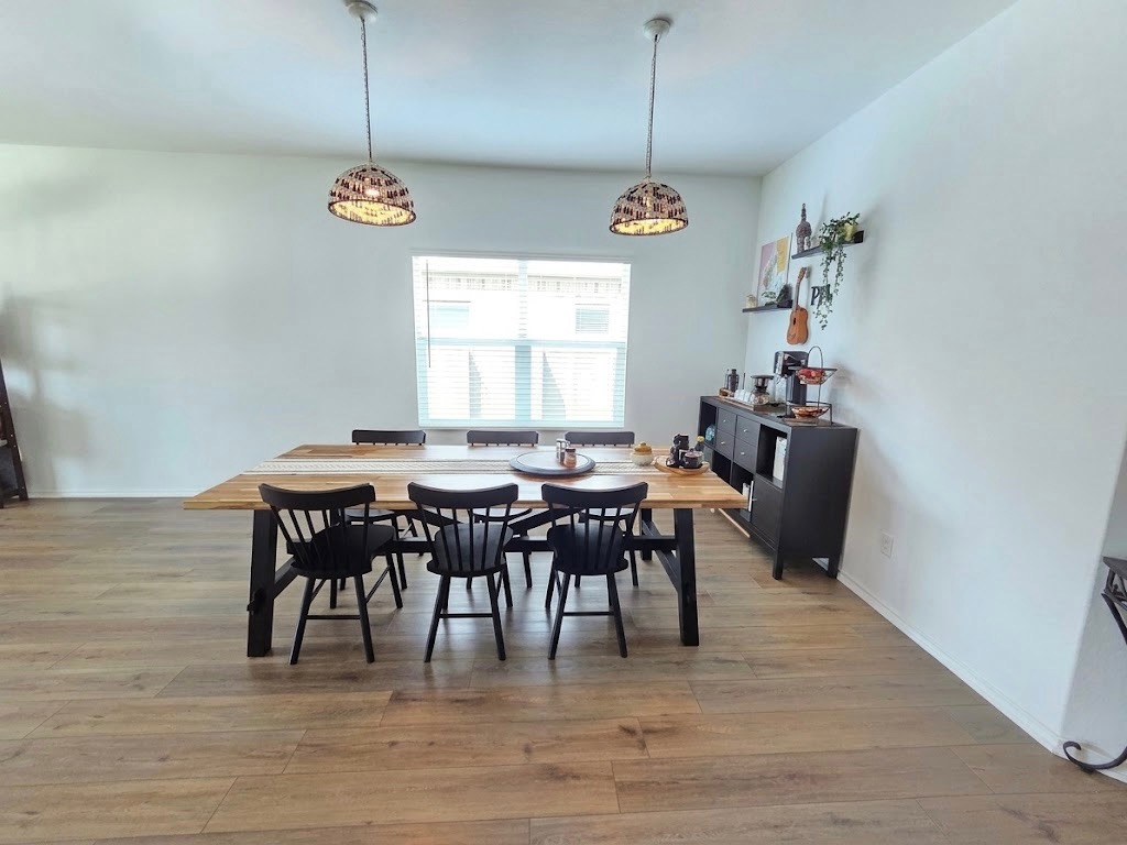 208 Wolf Springs Road Georgetown, TX 78628 - Photo 7 of 32 Natural light illuminates this spacious dining area with sleek flooring, perfect for gatherings.