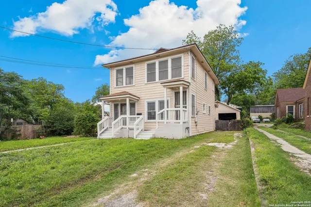 a front view of a house with a yard table and chairs
