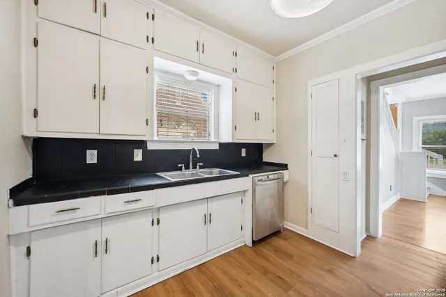 a kitchen with a sink and cabinets
