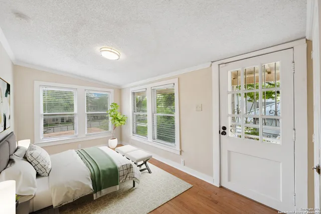 a bedroom with a bed and glass window