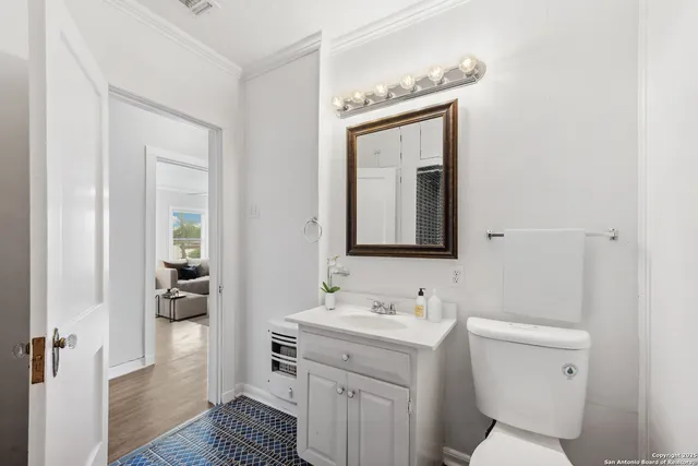 a bathroom with a toilet sink and mirror