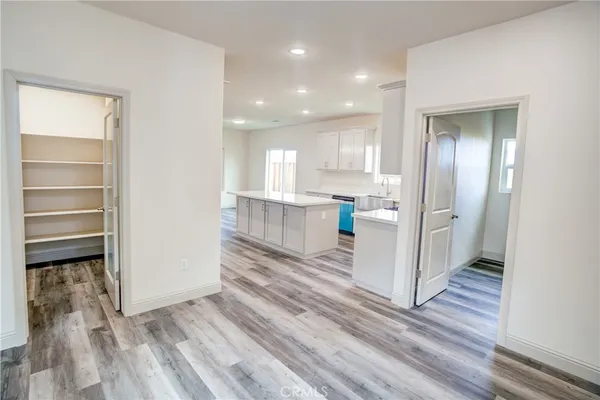 a view of a kitchen with wooden floor and a window