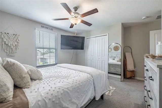 a bedroom with a large bed and a window