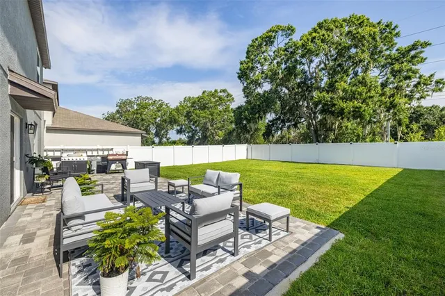 swimming pool with outdoor seating and green yard