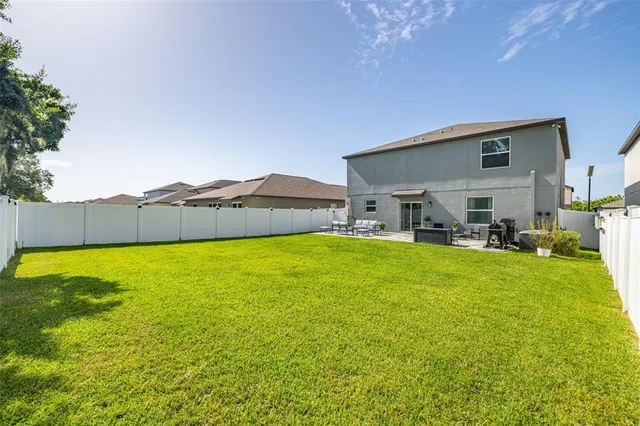 a view of a house with a backyard