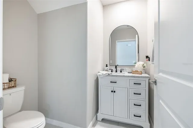 a bathroom with a sink a toilet and mirror
