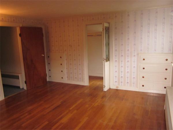 43 County Road Andover, MA 01810 - Photo 11 of 17 an empty room with wooden floor and cabinet