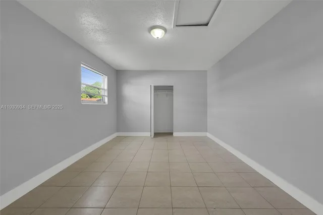 an empty room with windows and natural light