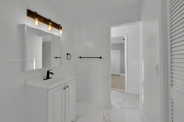 a bathroom with a sink a mirror and shower