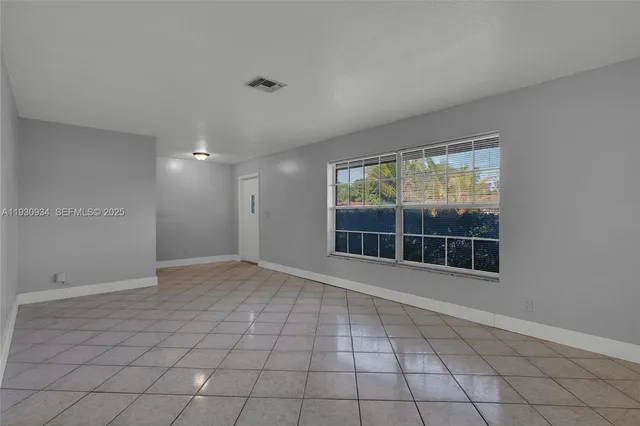 a view of empty room with windows