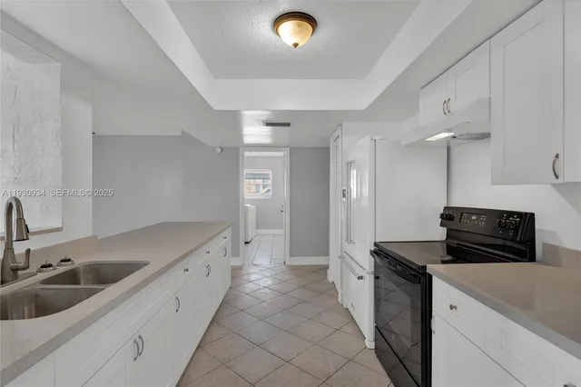 a kitchen that has a sink and a stove