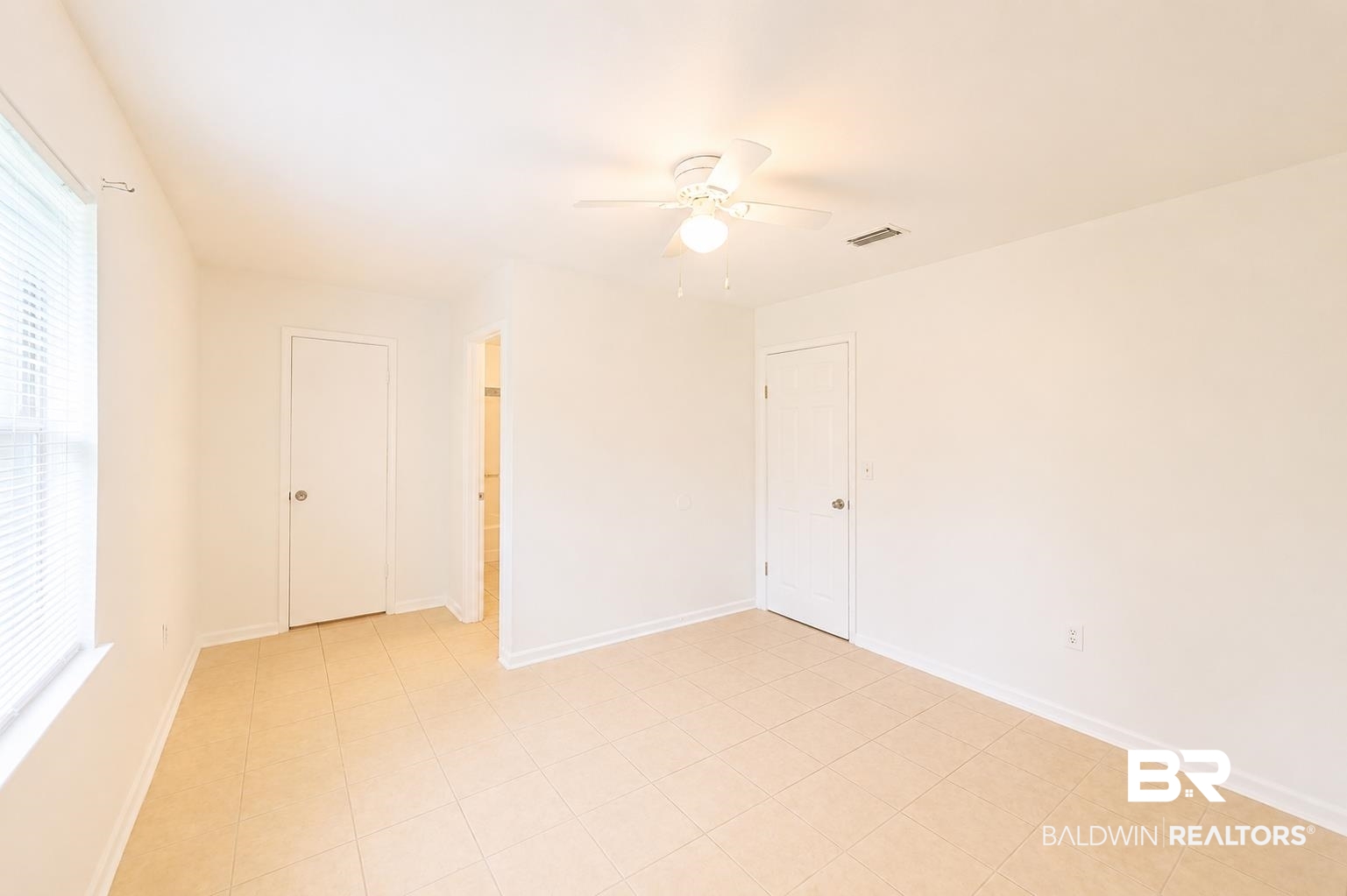 614 East Gate Circle Foley, AL 36535 - Photo 22 of 31 Spacious room featuring neutral-toned tile flooring and white walls