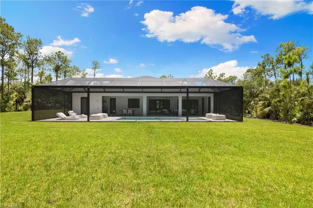 a front view of house with yard and outdoor seating