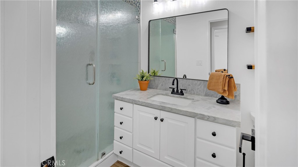16281 Golden Gate Lane Huntington Beach, CA 92649 - Photo 11 of 22 a bathroom with a sink and mirror