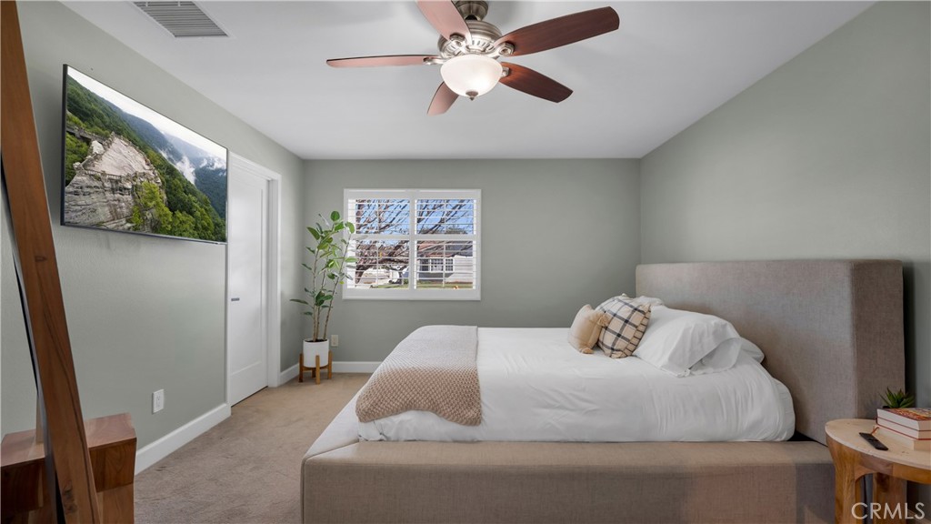 16281 Golden Gate Lane Huntington Beach, CA 92649 - Photo 12 of 22 a bedroom with a bed and a chandelier