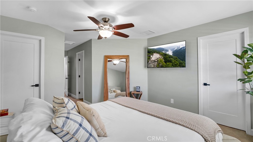 16281 Golden Gate Lane Huntington Beach, CA 92649 - Photo 14 of 22 a bedroom with a bed and a chandelier