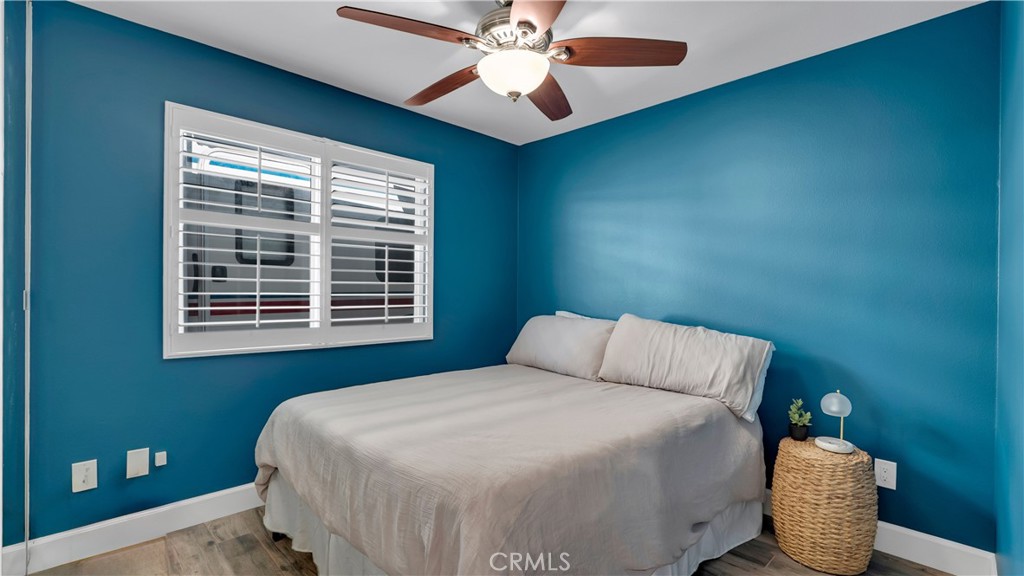 16281 Golden Gate Lane Huntington Beach, CA 92649 - Photo 18 of 22 a bedroom with a bed and a chandelier