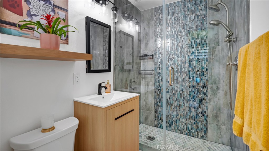 16281 Golden Gate Lane Huntington Beach, CA 92649 - Photo 20 of 22 a bathroom with a sink a toilet and shower