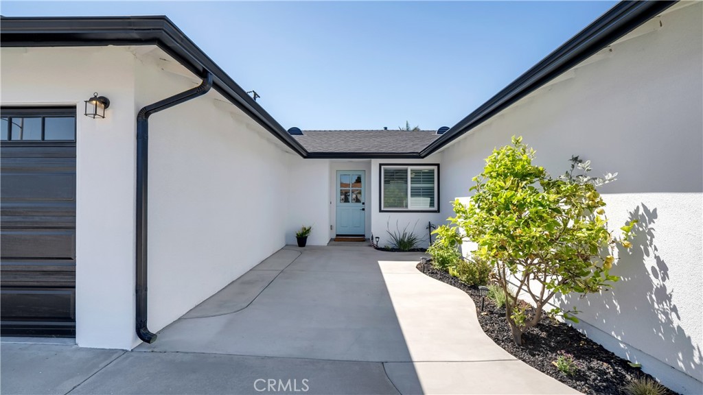 16281 Golden Gate Lane Huntington Beach, CA 92649 - Photo 4 of 22 a house with a potted plant in front of it