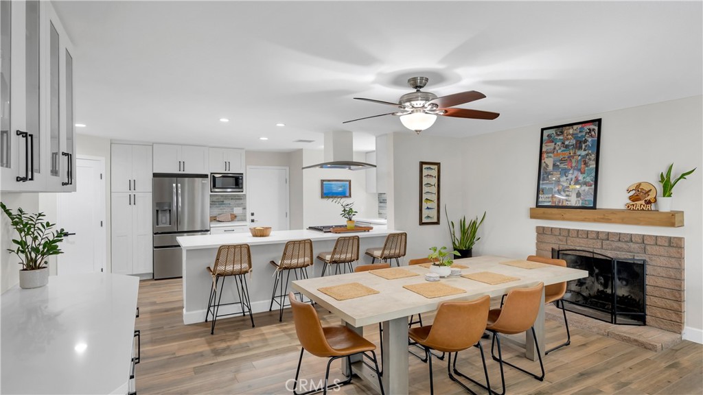 16281 Golden Gate Lane Huntington Beach, CA 92649 - Photo 5 of 22 a view of a dining room with furniture window and wooden floor