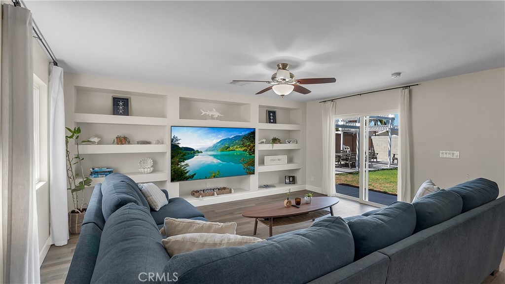 16281 Golden Gate Lane Huntington Beach, CA 92649 - Photo 6 of 22 a living room with furniture and a flat screen tv