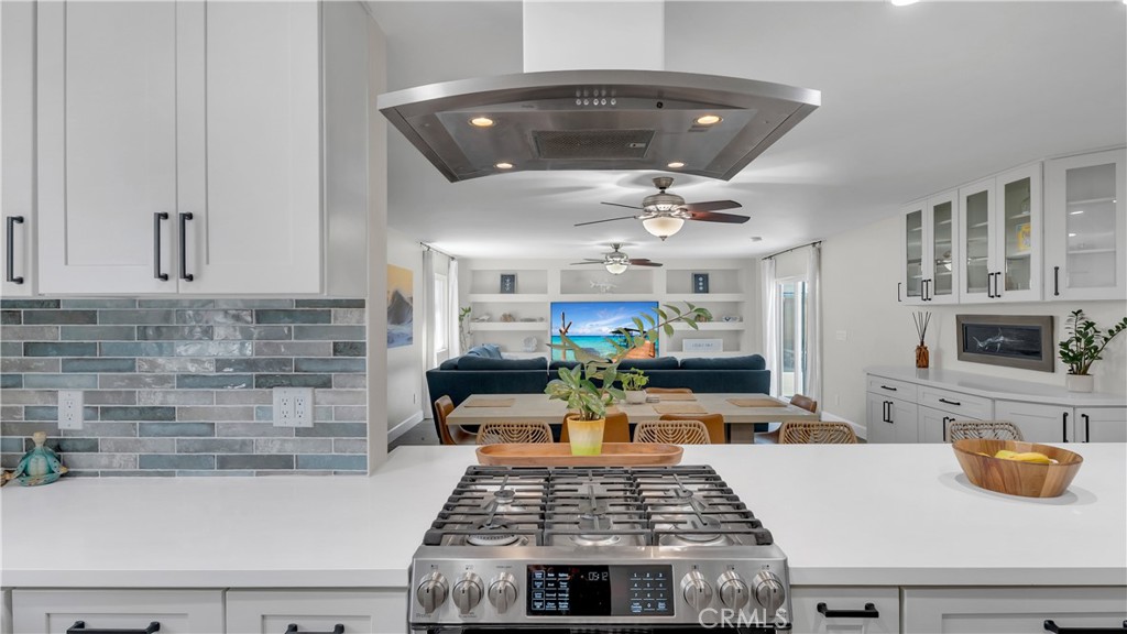 16281 Golden Gate Lane Huntington Beach, CA 92649 - Photo 7 of 22 a kitchen with a stove and white cabinets