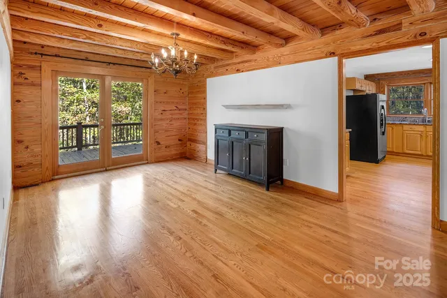 a view of empty room with wooden floor and fireplace