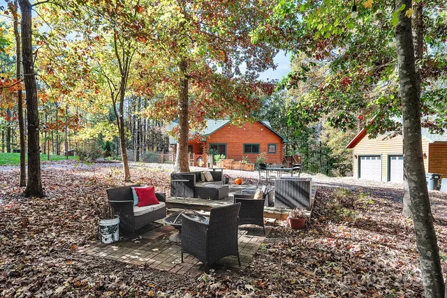 a view of a house with a yard and sitting area