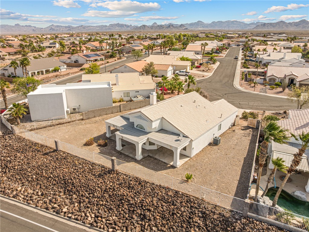 2853 Winchester Road Bullhead City, AZ 86442 - Photo 37 of 40 Aerial view of the property showcasing the white exterior, covered patio, and desert landscaping