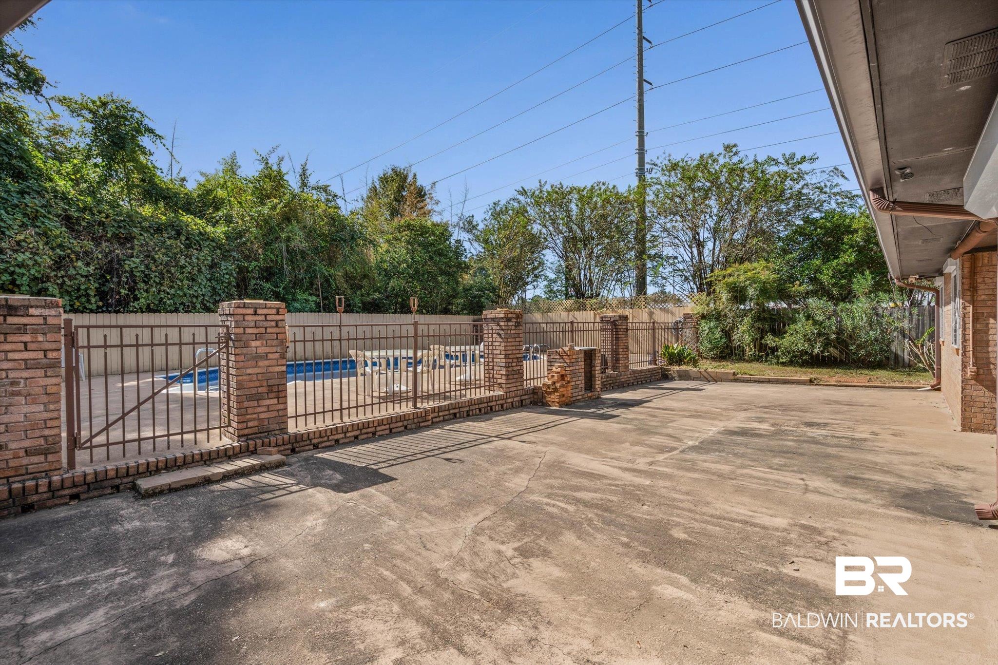 1900 Foxfire Road Mobile, AL 36618 - Photo 25 of 36 Gate featuring a patio and a fenced backyard
