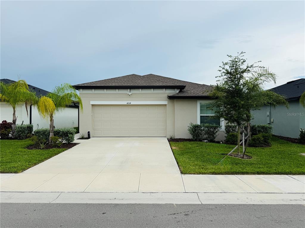 4034 San Clemente Court North Fort Myers, FL 33917 - Photo 1 of 22 a front view of a house with a yard and garage
