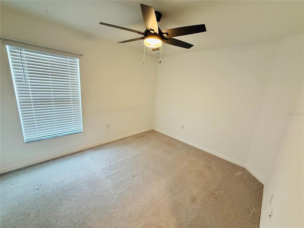 4034 San Clemente Court North Fort Myers, FL 33917 - Photo 11 of 22 an empty room with a window and a fan