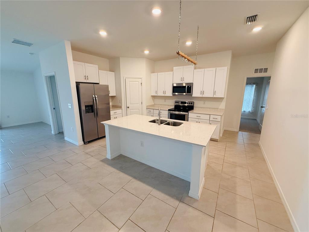 4034 San Clemente Court North Fort Myers, FL 33917 - Photo 16 of 22 a kitchen with stainless steel appliances a refrigerator sink and microwave