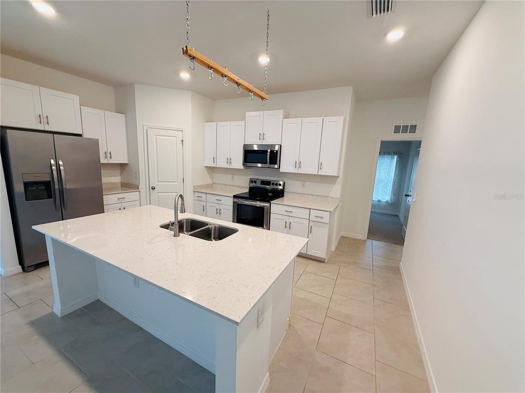 4034 San Clemente Court North Fort Myers, FL 33917 - Photo 19 of 22 a kitchen with stainless steel appliances a refrigerator sink and microwave