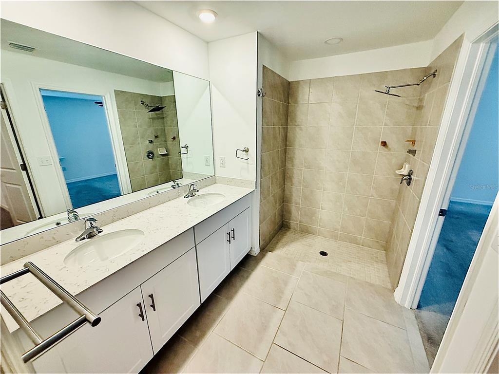 4034 San Clemente Court North Fort Myers, FL 33917 - Photo 22 of 22 a bathroom with a double vanity sink mirror double and shower