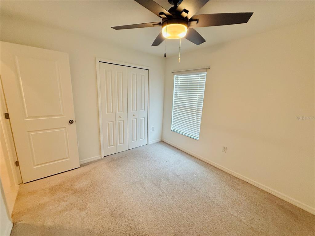 4034 San Clemente Court North Fort Myers, FL 33917 - Photo 10 of 22 an empty room with windows and fan