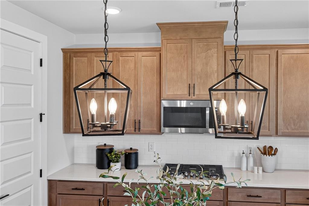 2600 Parkside Way Gainesville, GA 30507 - Photo 11 of 41 a kitchen with a sink a microwave a stove and cabinets