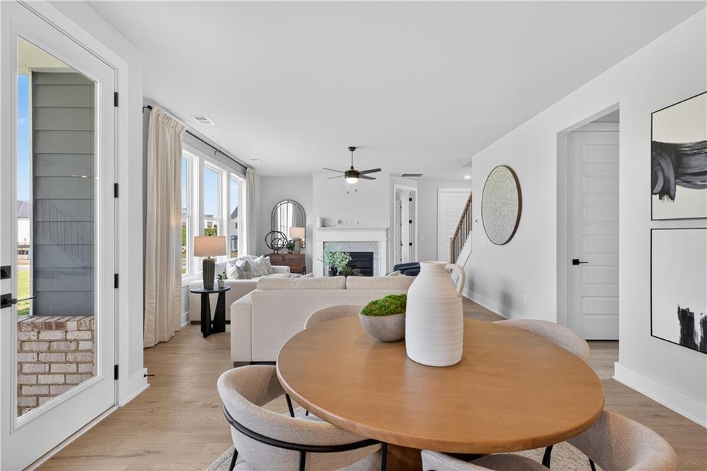2600 Parkside Way Gainesville, GA 30507 - Photo 14 of 41 a view of a dining room with furniture a fireplace and wooden floor
