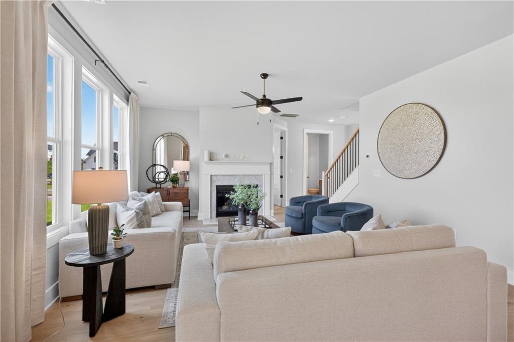 2600 Parkside Way Gainesville, GA 30507 - Photo 15 of 41 a living room with furniture a fireplace and a chandelier