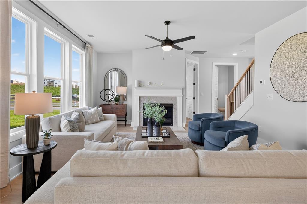 2600 Parkside Way Gainesville, GA 30507 - Photo 16 of 41 a living room with furniture a fireplace and a chandelier