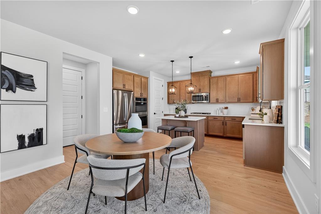 2600 Parkside Way Gainesville, GA 30507 - Photo 7 of 41 a kitchen with a dining table chairs and refrigerator