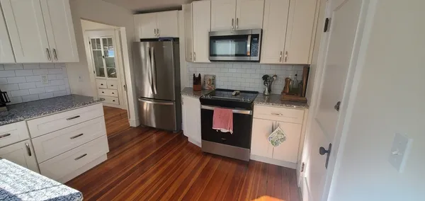 a kitchen with stainless steel appliances granite countertop a refrigerator stove and sink