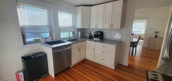 a kitchen with cabinets appliances and a window