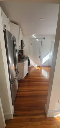 a kitchen with granite countertop a refrigerator and a sink
