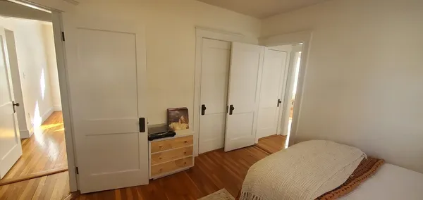 a bedroom with a bed and a closet